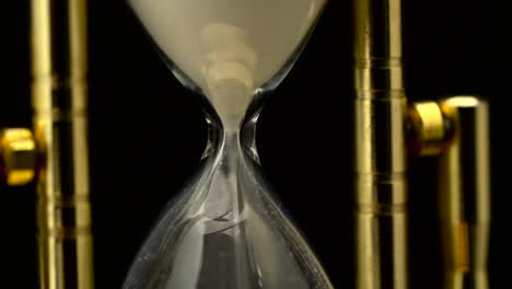 time flowing: close-up of an hourglass with sand