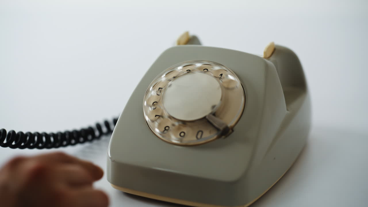 Hands using stationary telephone for communication at home closeup. Man picking