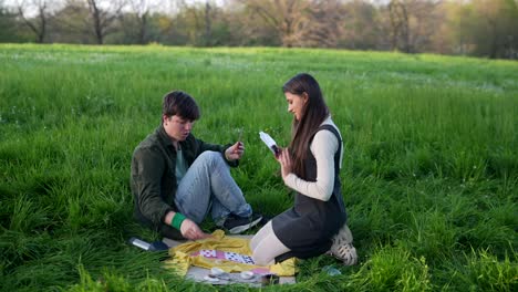 couple playing cards in a park