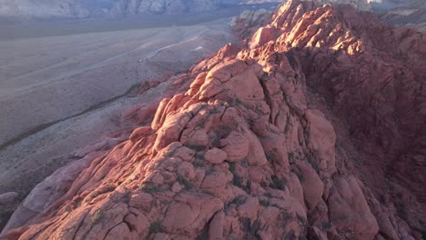 aerial-footage-of-red-rock-formation-in-Las-Vegas-during-epic-sunset,-drone-fly-close-canyon