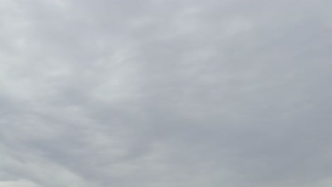 light gray cloud time lapse, bad weather coming in, fast flowing clouds