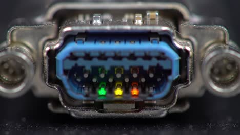 detailed close-up of a data connection port with colorful indicator lights illuminated in green, yellow, and red. the setting is a tech environment where connectivity is essential.