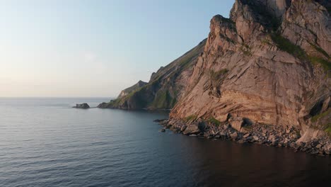 Drone-shot-of-remote-Horseid-sand-beach-surrounded-by-steep-cliffs-in-Norway-Lofoten