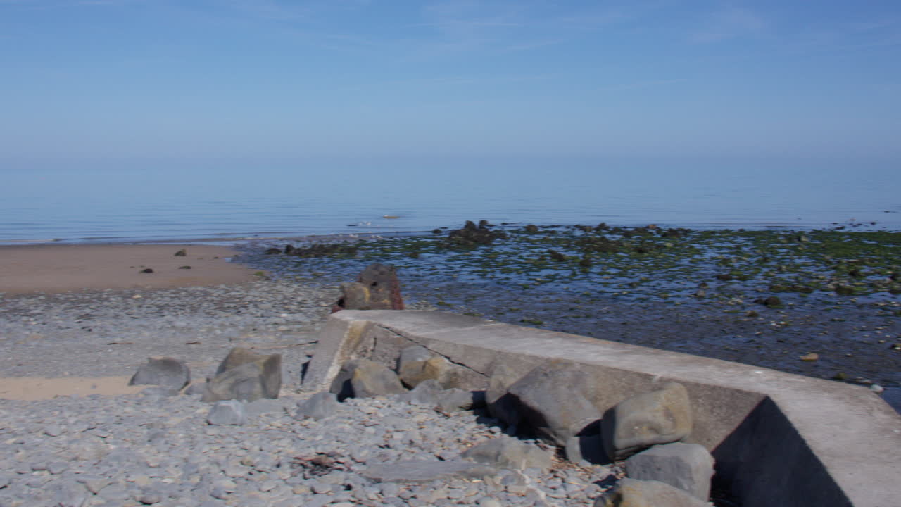 Extra wide panning shot of new quay next to the river Gido on new quay beach