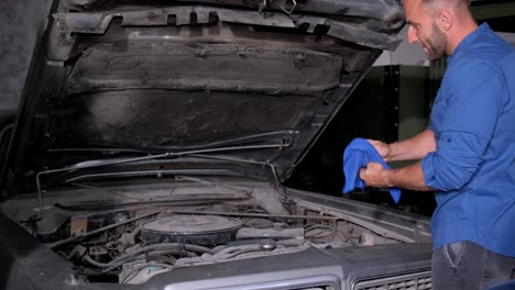 man working on a classic car engine