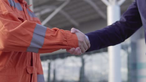 professional worker shaking hands with businessman in a suit. close up view