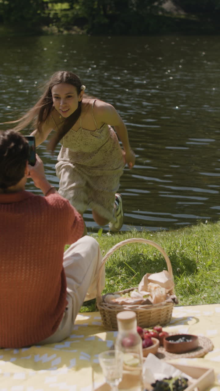 Couple enjoying a picnic by the lake