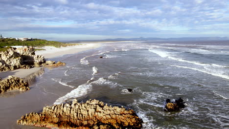 grotto blue flag beach with rocks and sand in hermanus, scenic location