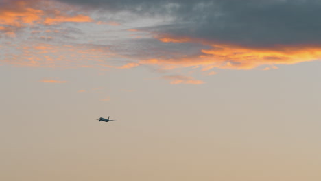 airplane flying in the evening sky