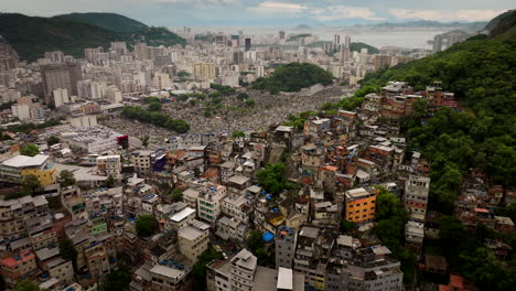 contrast between sprawling favela, adjacent são joão batista cemetery, and dense cityscape of rio de janeiro, brazil. aerial backward