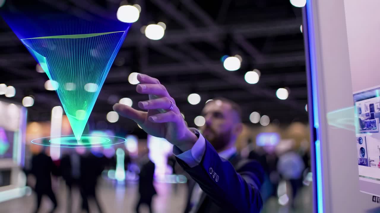 Wide-angle shot of a modern exhibition hall filled with people and digital displays