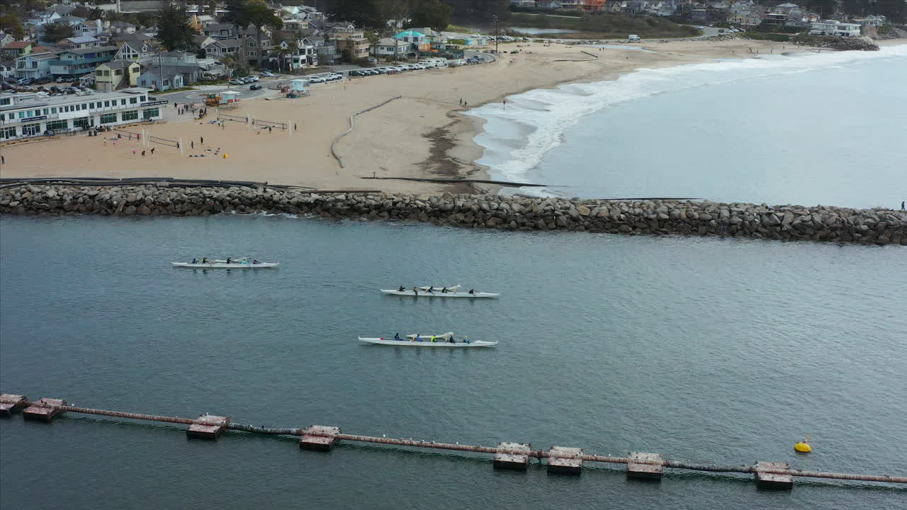 Aerial drone tracking shot of canoe racing off of the coast of Santa Cruz, California, USA