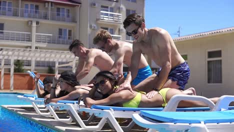 women receiving massage from their boyfriends at a beautiful villa by the pool. slow motion shot