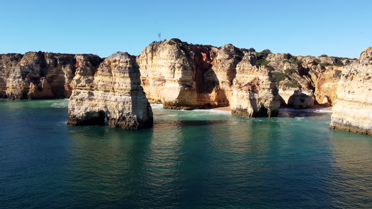 Aerial shot of Ponta da Piedade cliffs in the Algarve, sunny morning light. Hovering above the Atlantic Ocean. Europe Portugal