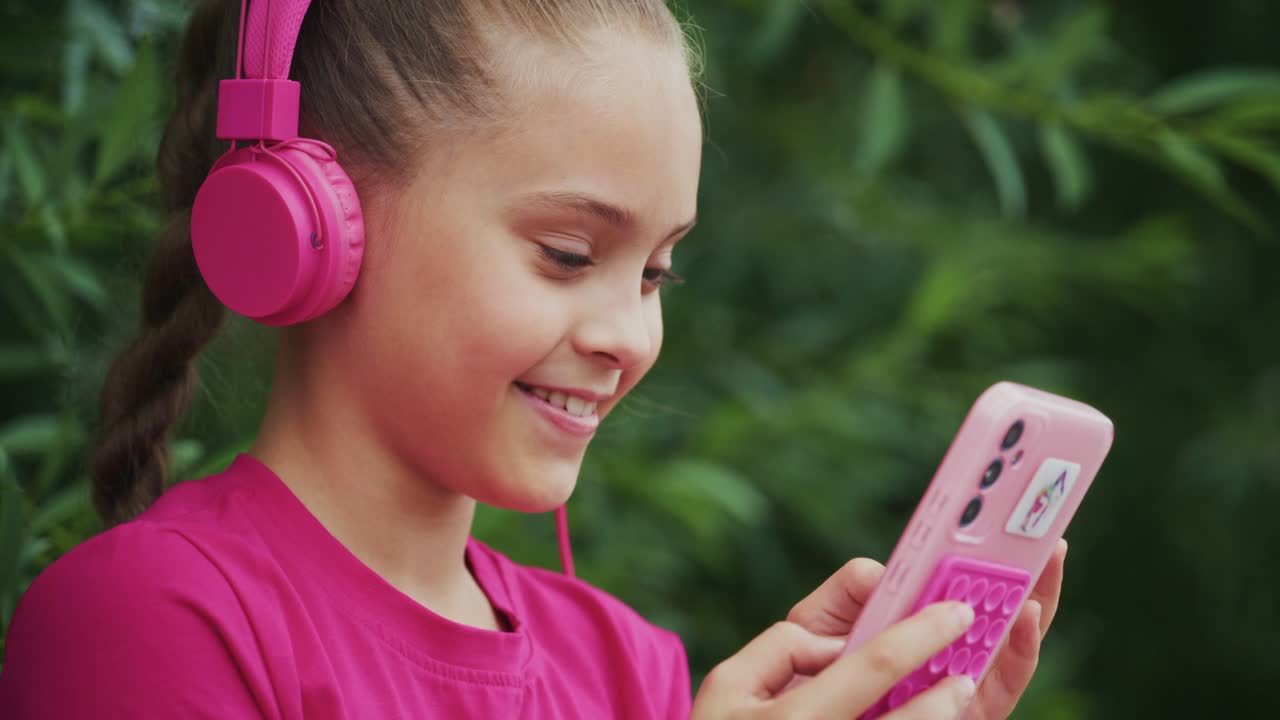 A Young Girl Enjoys Listening to Music While Using Her Smartphone, Captured in Two Frames Showcasing Her Joy and Engagement in a Natural Green Setting