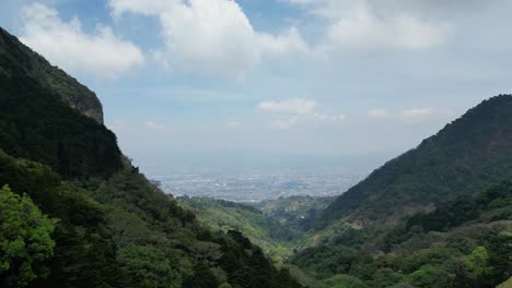 Beautiful-Drone-Shot-of-Central-Valley-of-Costa-Rica-in-Distance-Between-Two-Mountains