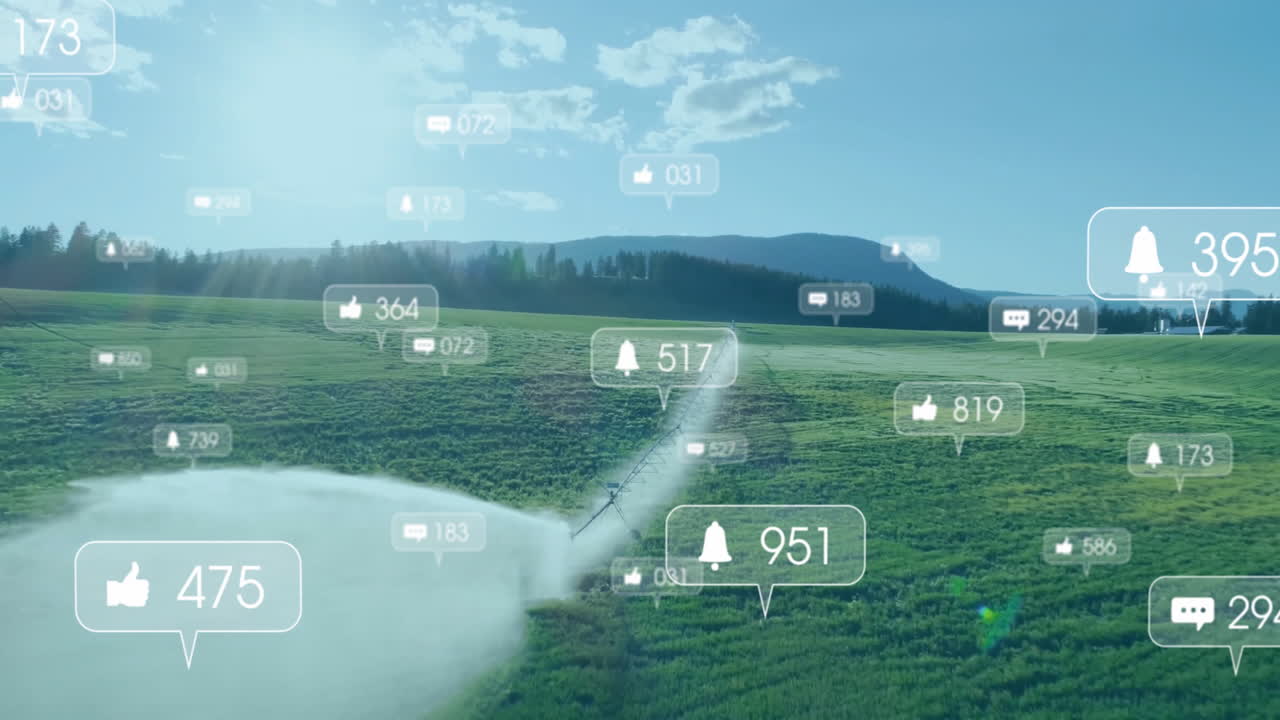 Central pivot irrigation machine spraying water across field, showing thumbs up comment bell icons