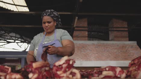 african woman looking at the meat