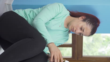 Vertical-video-of-Suicide-woman-leaning-against-the-wall.