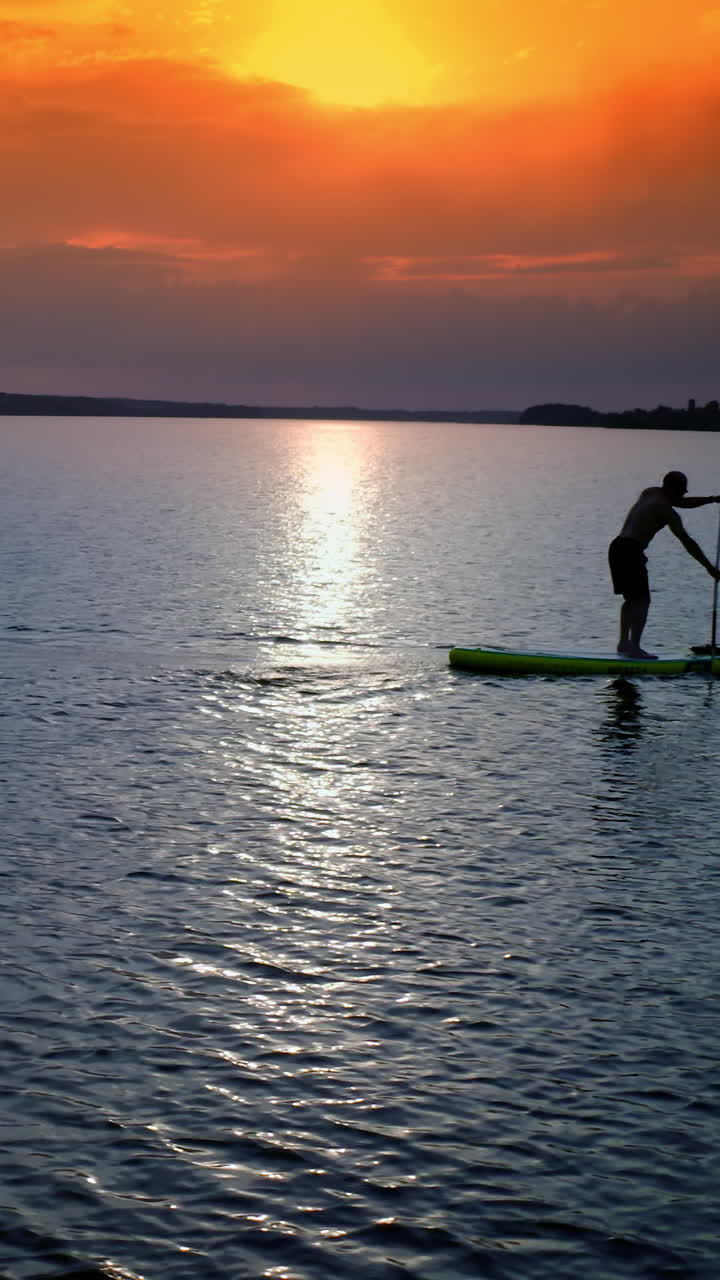 Man on stand up paddle board. Athlete man floating sup board on vacation