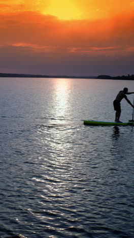 man on stand up paddle board. athlete man floating sup board on vacation
