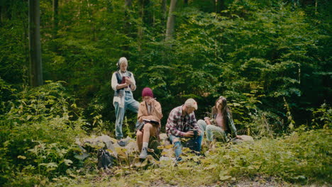 male and female hikers amidst trees in forest