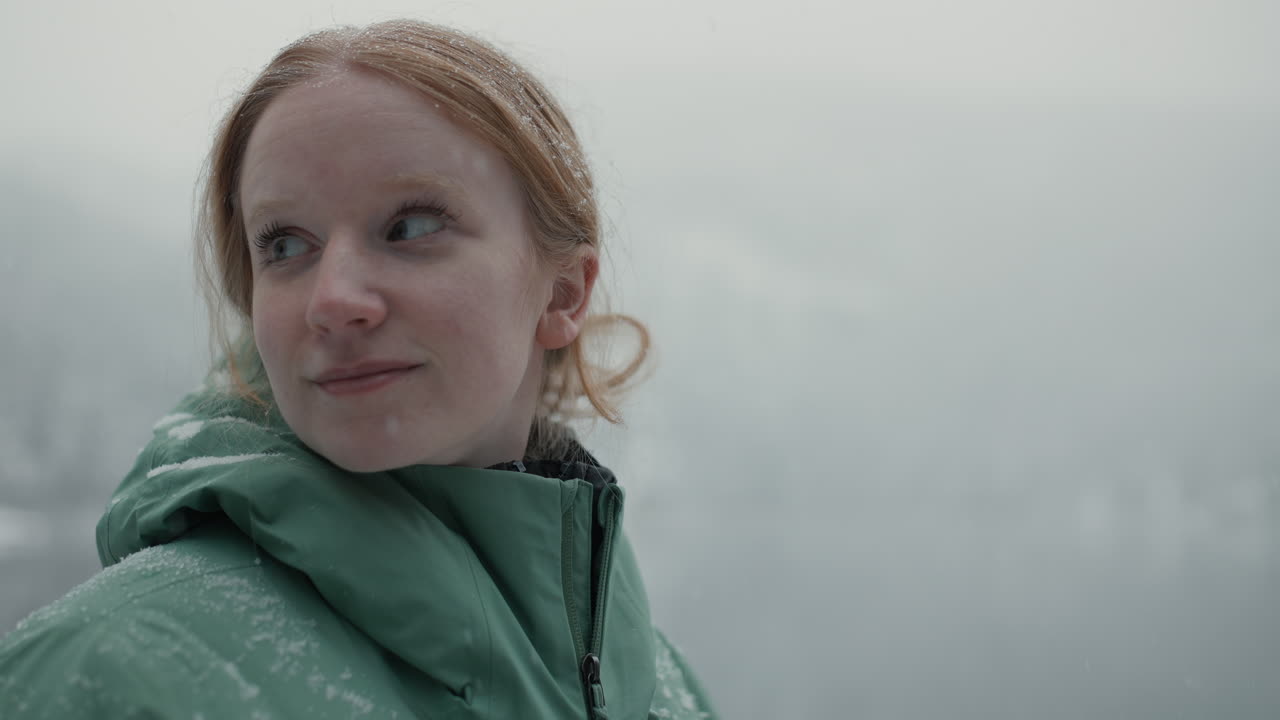 Woman Hiking in Snowy Mountains near a Lake