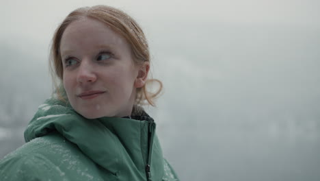 woman hiking in snowy mountains near a lake