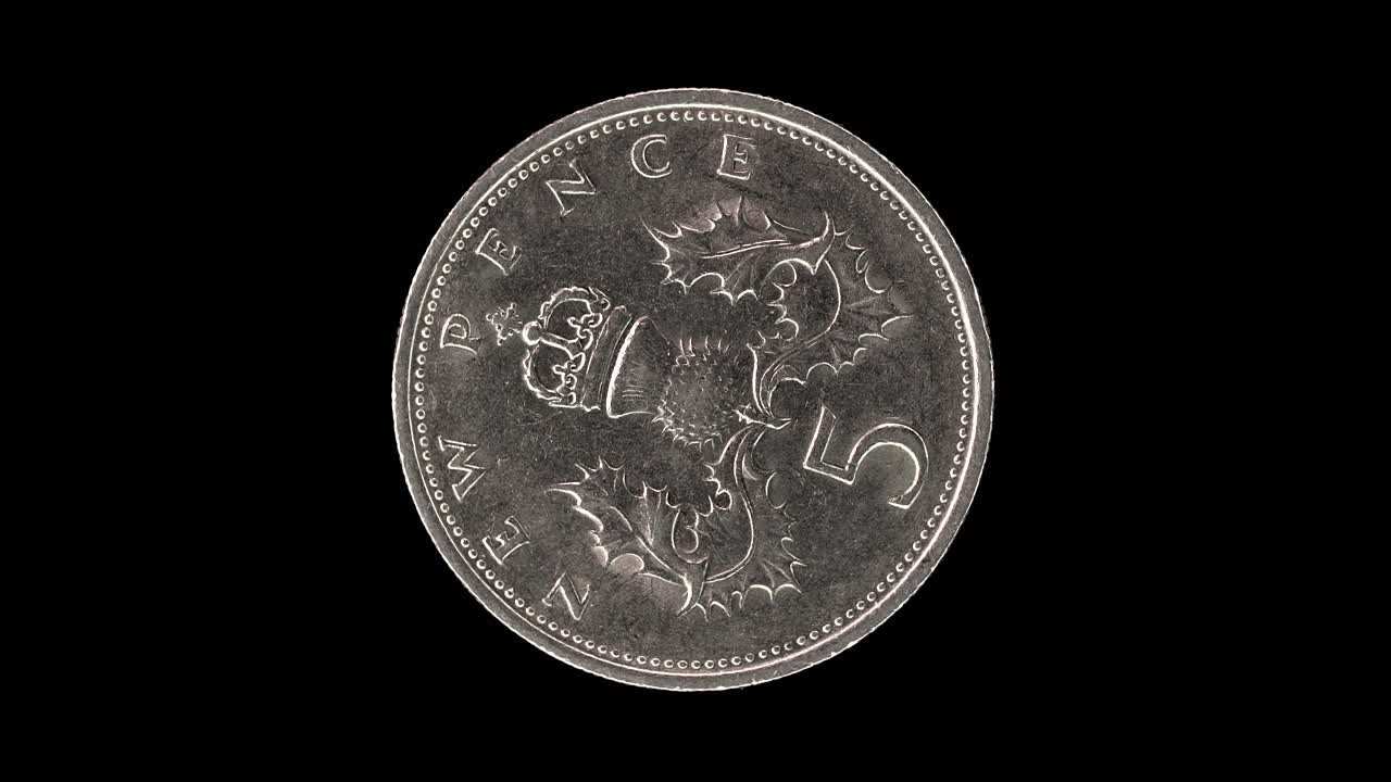 United Kingdom 1970 five new pence coin reverse with crowned thistle badge rotating on black background