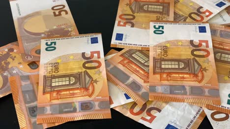 50 euro banknotes fall slowly on table