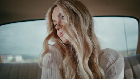 portrait gorgeous blonde model relaxing on back seat luxury classic automobile.