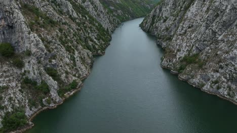 aerial pullback rugged narrow canyon - hydroelectric reservoir water