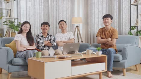 asian teen group studying at home, doing project, smiling and showing arms crossed gesture