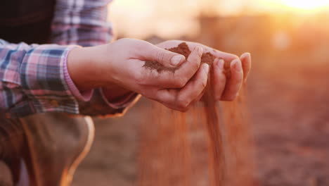 farmer hands with black soil organic farming concept