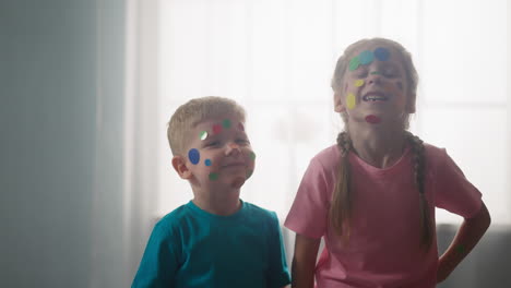 Little-brother-and-sister-with-polka-dot-on-faces-in-room