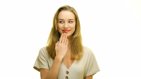 the young embarrassed woman gestures and raises her hand to her lips