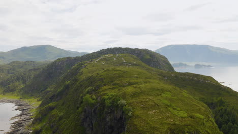 Green-Rocky-Mountain-In-The-Island-Of-Vagsoy-At-The-Coast-Of-Misty-Fjord-In-Maaloy,-Norway