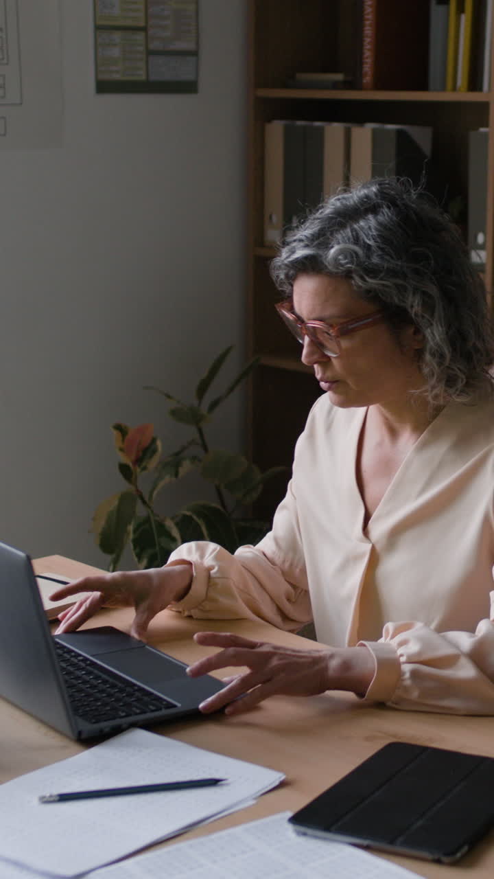 Teacher working on laptop in classroom