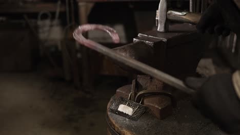 blacksmith at work, forging a horseshoe