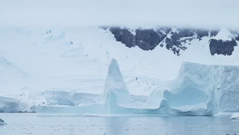 large antarctica icebergs winter scenery, amazing shapes ice formations of massive big enormous blue iceberg in beautiful antarctic peninsula landscape seascape with ocean sea water