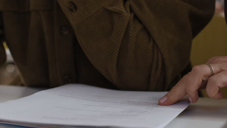 person writing on paper with a pen