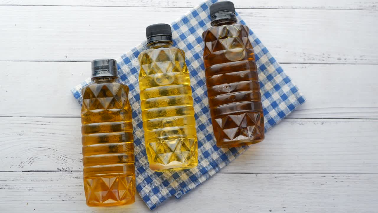 Mustard oil in a plastic jar on table  high quality 4k footage