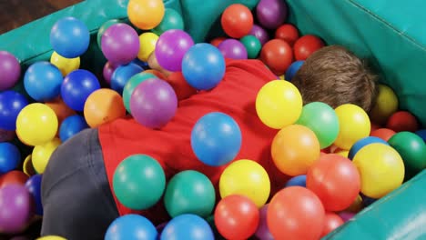 boy playing in ball pool 4k