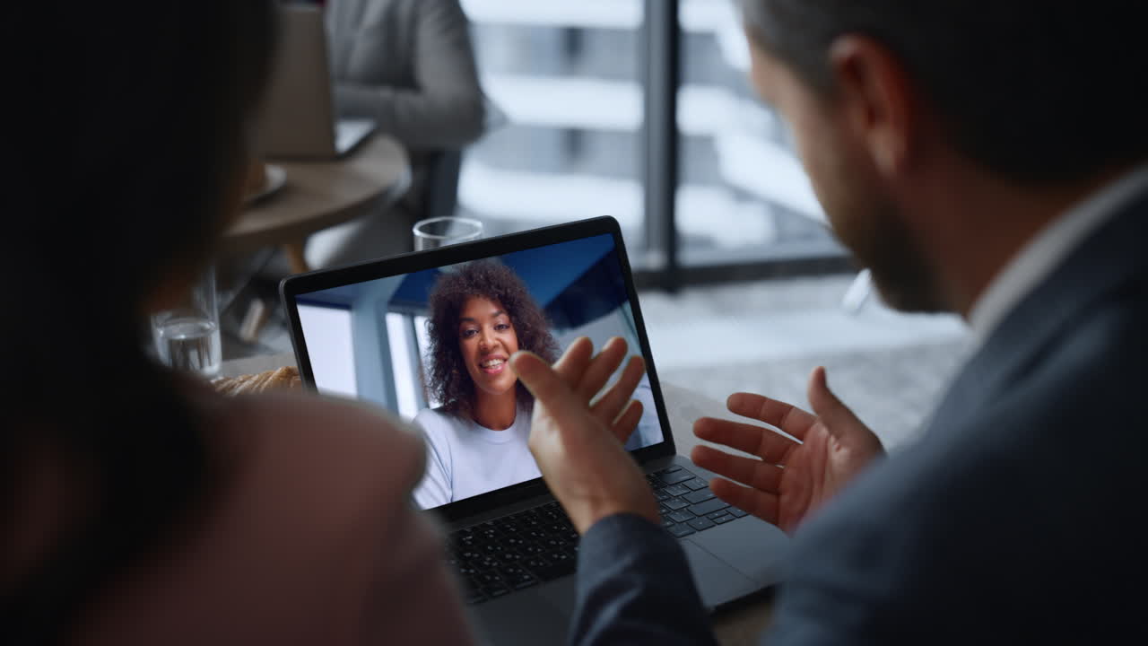 Group employees video calling laptop in restaurant close up. Remote meeting