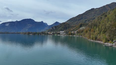 Aerial-flyover-lake-walen-during-cloudy-day-in-swiss-mountains---Approaching-shot---weesen,-switzerland