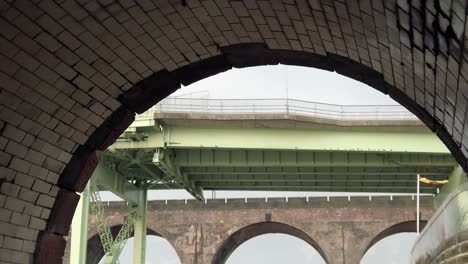 Old-industrial-arches-view-of-Runcorn-Silver-Jubilee-bridge---brick-arches-railway-crossing