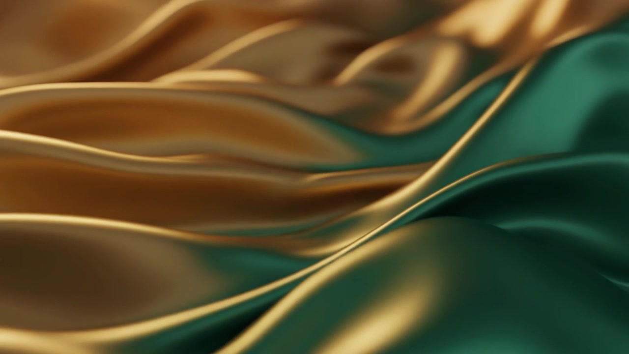 Sfondo astratto di tessuto di seta fluente color oro e verde smeraldo