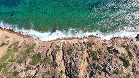 aerial footage of waves on a rocky shore