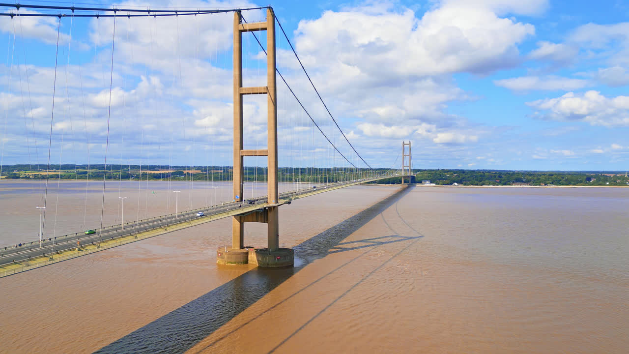 Aerial drone's view of Humber Bridge, 12th largest single-span worldwide, arching over River Humber, serving Lincolnshire to Humberside traffic seamlessly