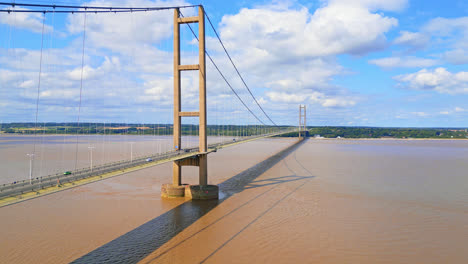 Aerial-drone's-view-of-Humber-Bridge,-12th-largest-single-span-worldwide,-arching-over-River-Humber,-serving-Lincolnshire-to-Humberside-traffic-seamlessly